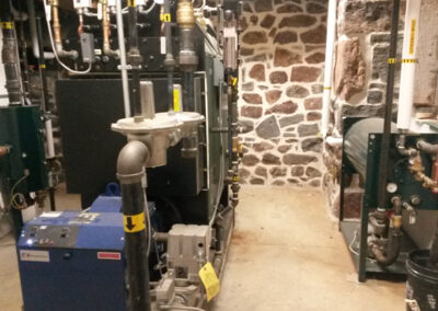 Distilling requires consistent heat - provided by their Columbia HP 50 boiler. At left, their blowdown separator and at right their boiler feed system, automate important boiler functions.